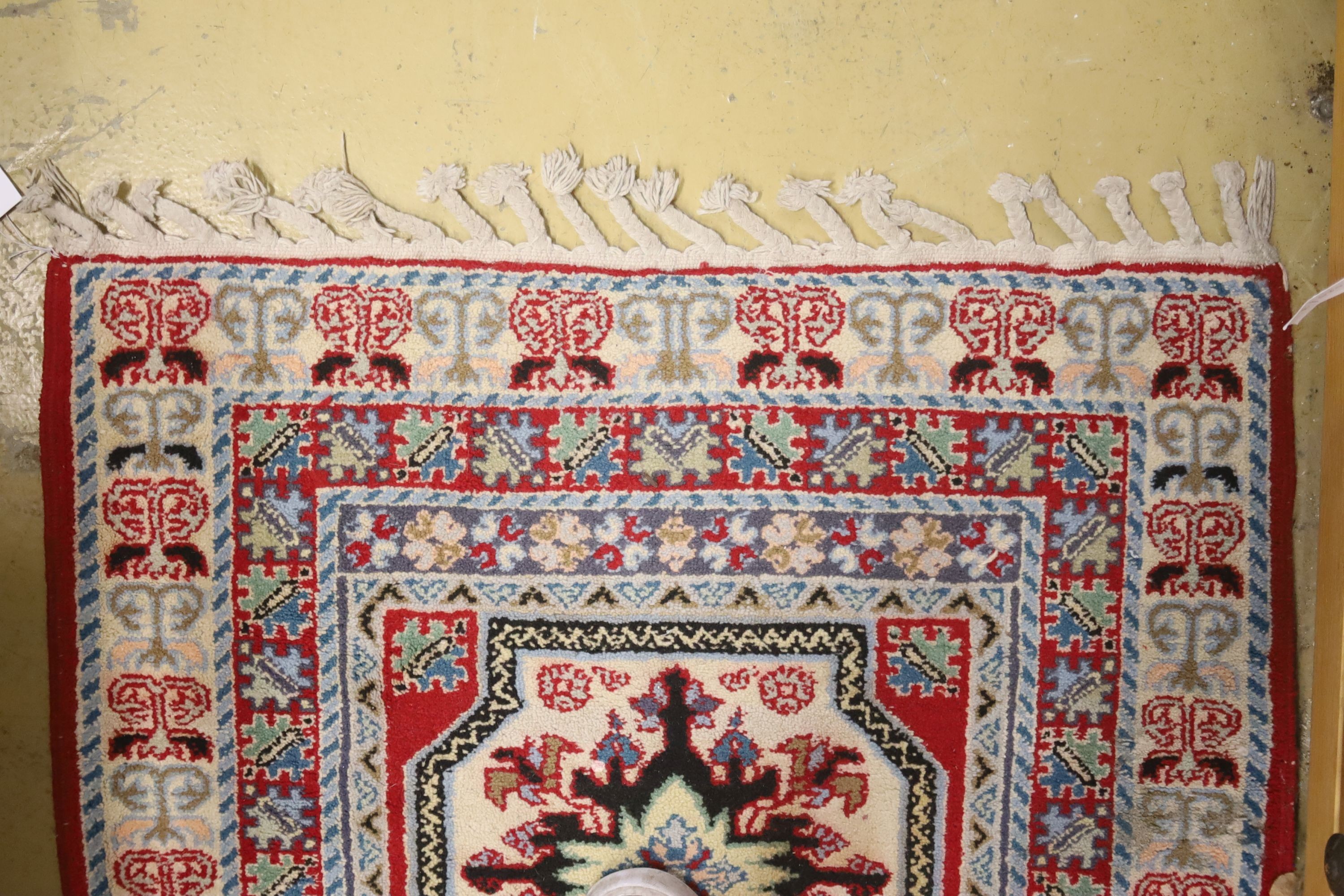 A Kazak style ivory ground rug, 144 x 64cm